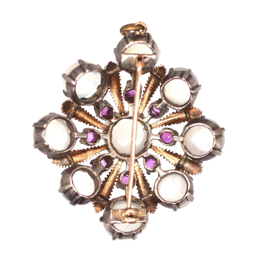 Artistic silver and gold brooch pendant featuring moonstones and natural rubies, dating back to 1910.