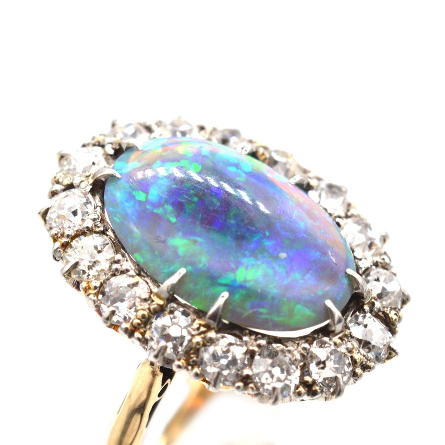 Large Victorian 18ct gold ring featuring a stunning black opal surrounded by sparkling diamonds.
