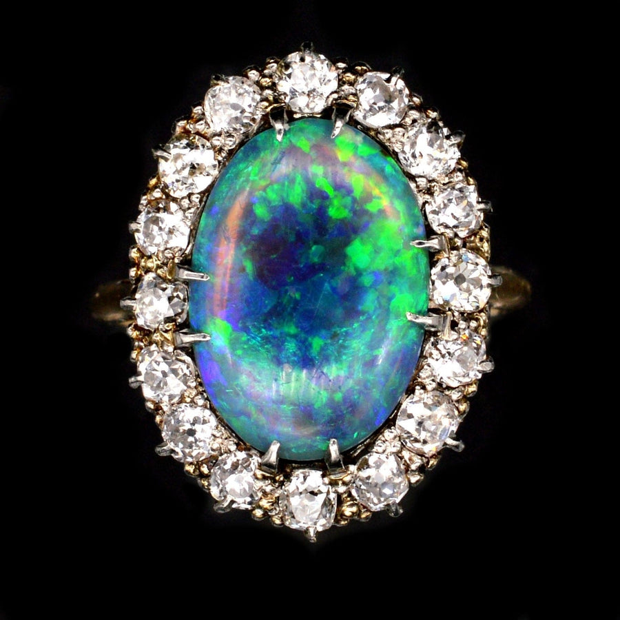 Large Victorian 18ct gold ring featuring a stunning black opal surrounded by diamonds.