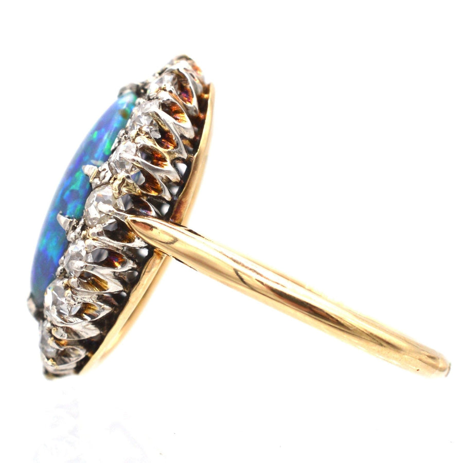 Side view of a large Victorian 18ct gold ring featuring a stunning black opal surrounded by diamonds.