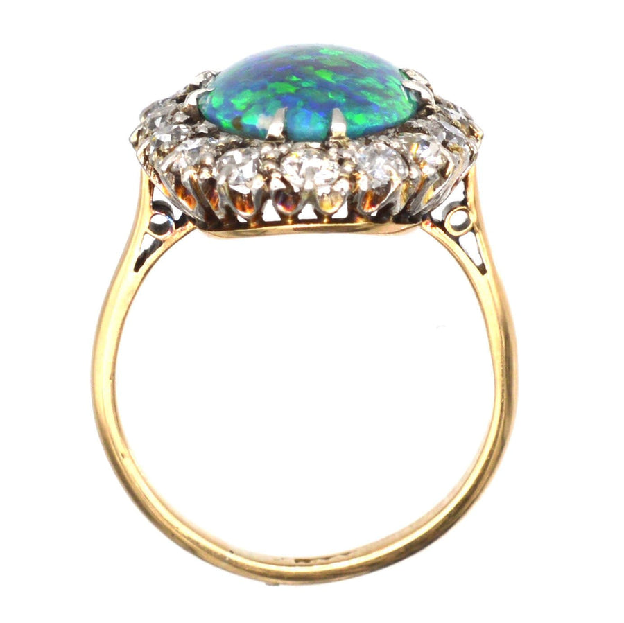 Large Victorian 18ct gold ring featuring a stunning black opal surrounded by sparkling diamonds.