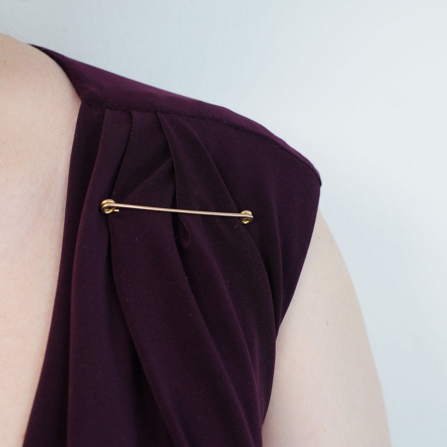 Large Victorian 9ct gold stock pin brooch showcased on a purple garment, blending fashion and history.
