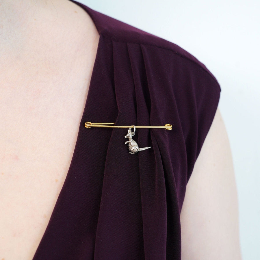 Large Victorian 9ct Gold stock pin brooch worn on a dark purple garment, showcasing its elegant design.