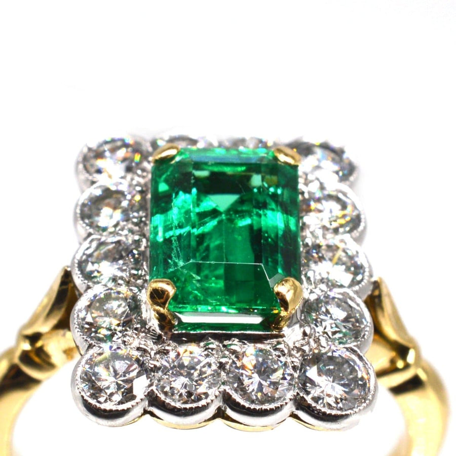 Large vintage 18ct gold and platinum emerald and diamond cluster ring with 1.70ct emerald and 1.50ct diamonds.