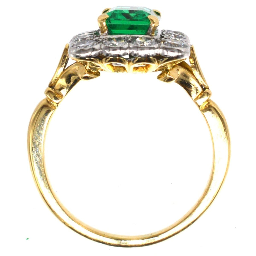 Large vintage 18ct gold and platinum emerald diamond cluster ring, featuring a 1.70 carat Brazilian emerald centerpiece.