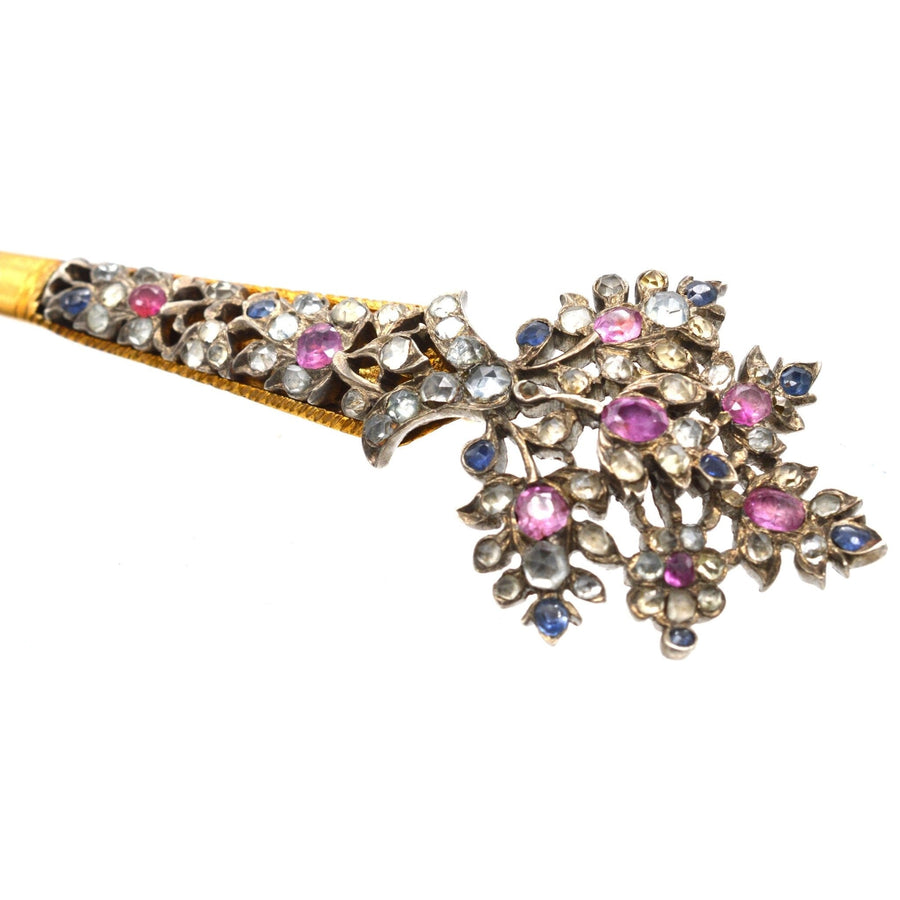 Vintage Sri Lankan kondakoora hairpin, adorned with sapphires and pink gems, showcasing intricate floral design.