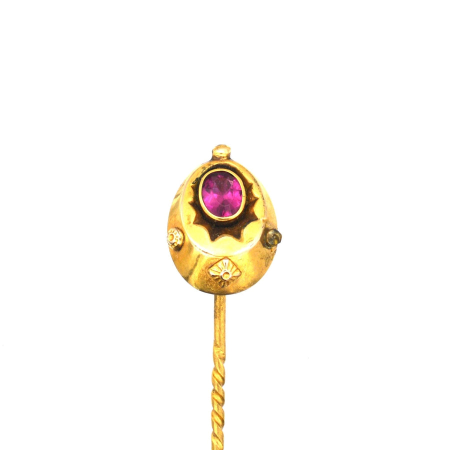 Late Victorian 15ct gold tie pin with red paste 'ruby' gemstone, circa 1890-1900, featuring ornate details.