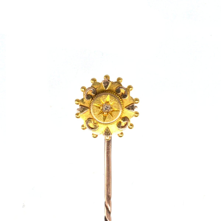 Late Victorian 15ct gold star tie pin with old cut diamond and elegant details.