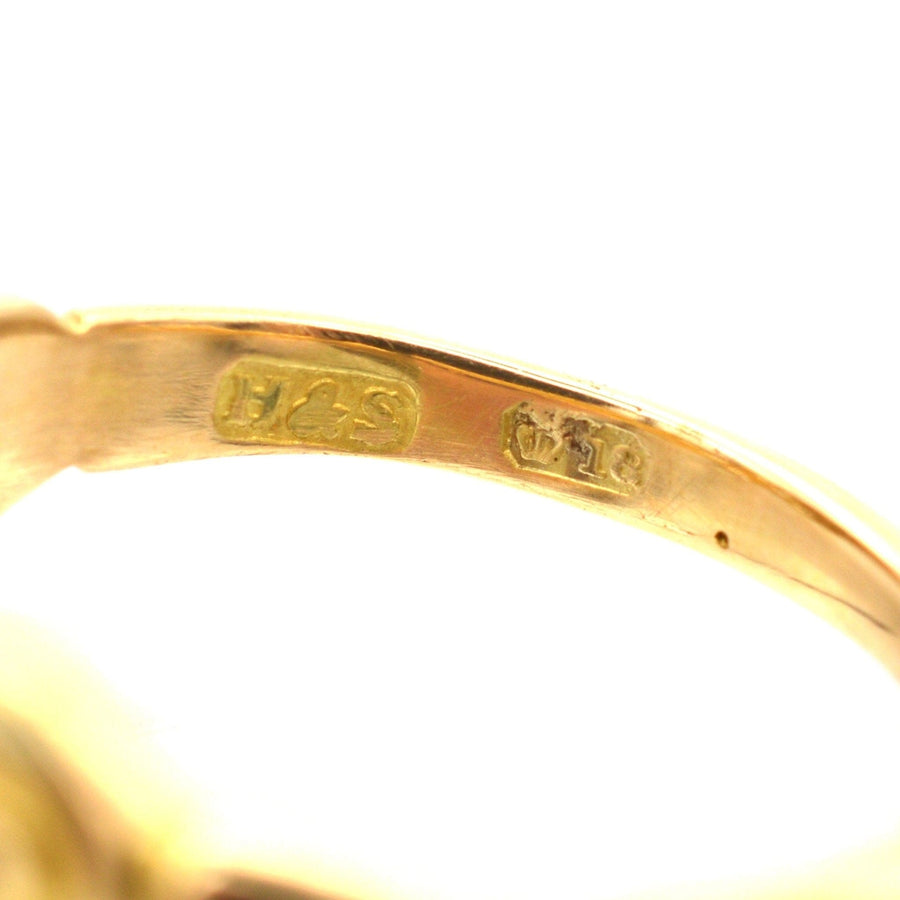 Close-up of the hallmark and gold purity stamp on the inside of a Late Victorian 18ct gold ring.
