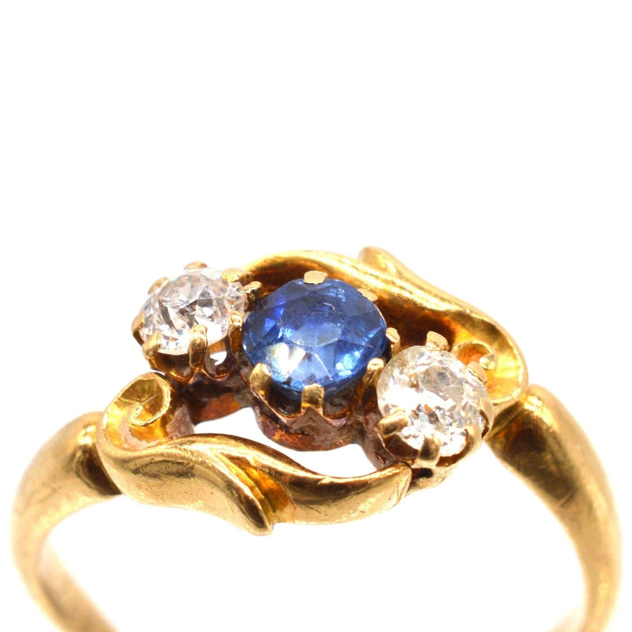 Late Victorian 18ct gold crossover ring featuring sapphire and diamond, crafted in Birmingham, 1900.