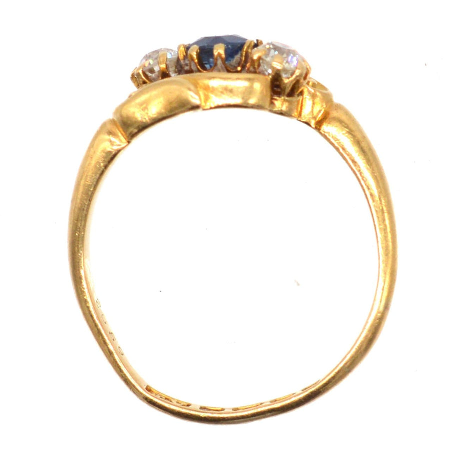 Late Victorian 18ct gold three stone sapphire and diamond crossover ring, intricately carved, Art Nouveau style.