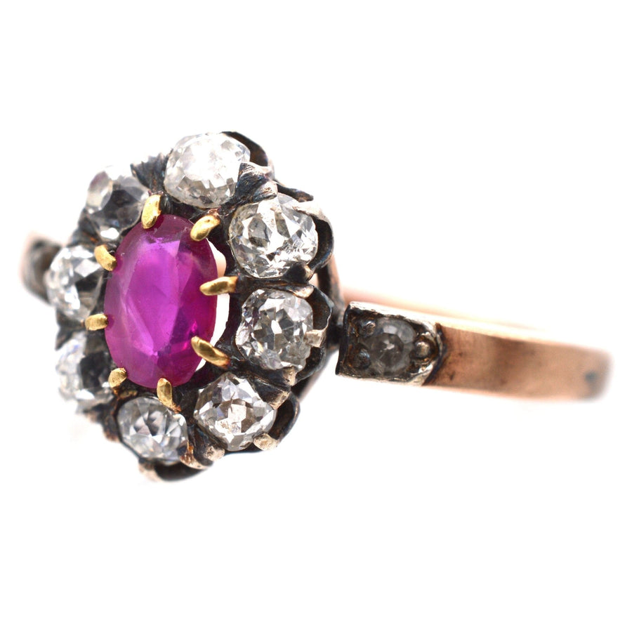 Victorian ruby and diamond cluster ring in rose gold, featuring a vibrant purple ruby surrounded by old mine cut diamonds.