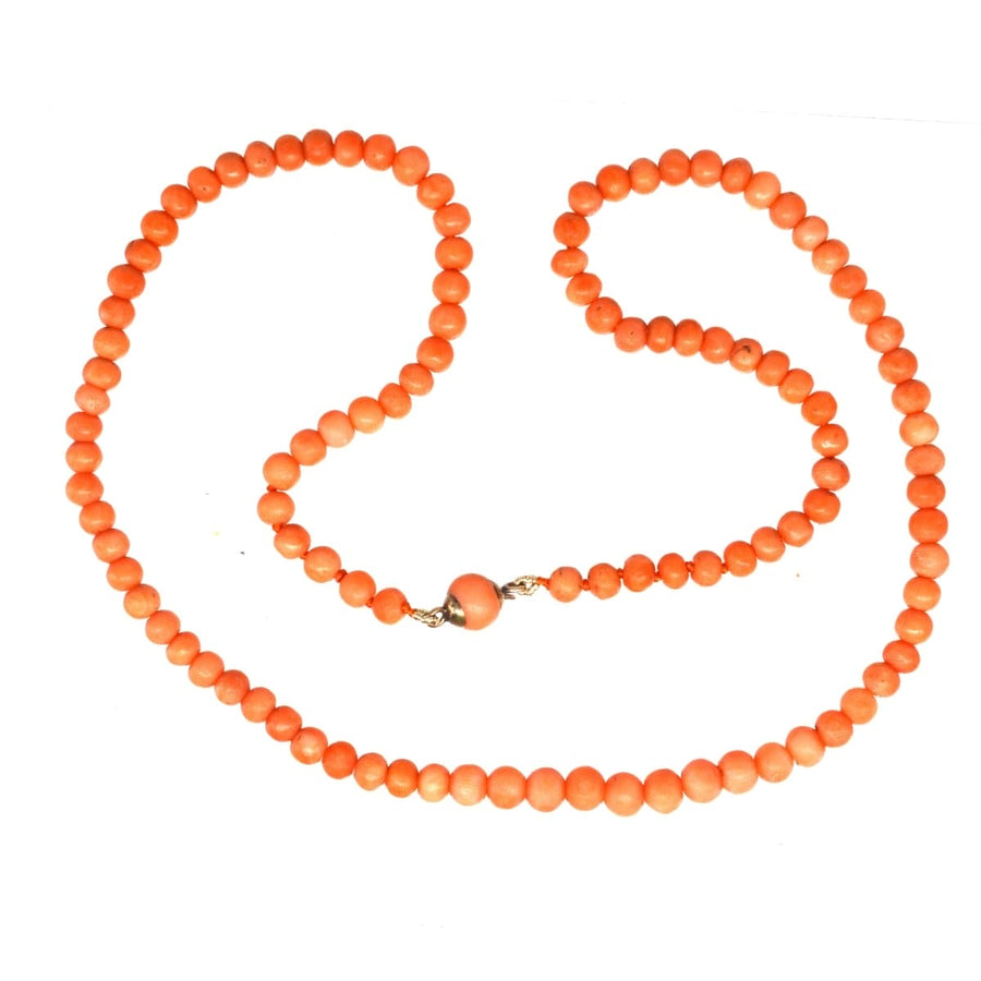 Mid 19th century gold coral bead necklace featuring salmon coral beads and a secure gold clasp.
