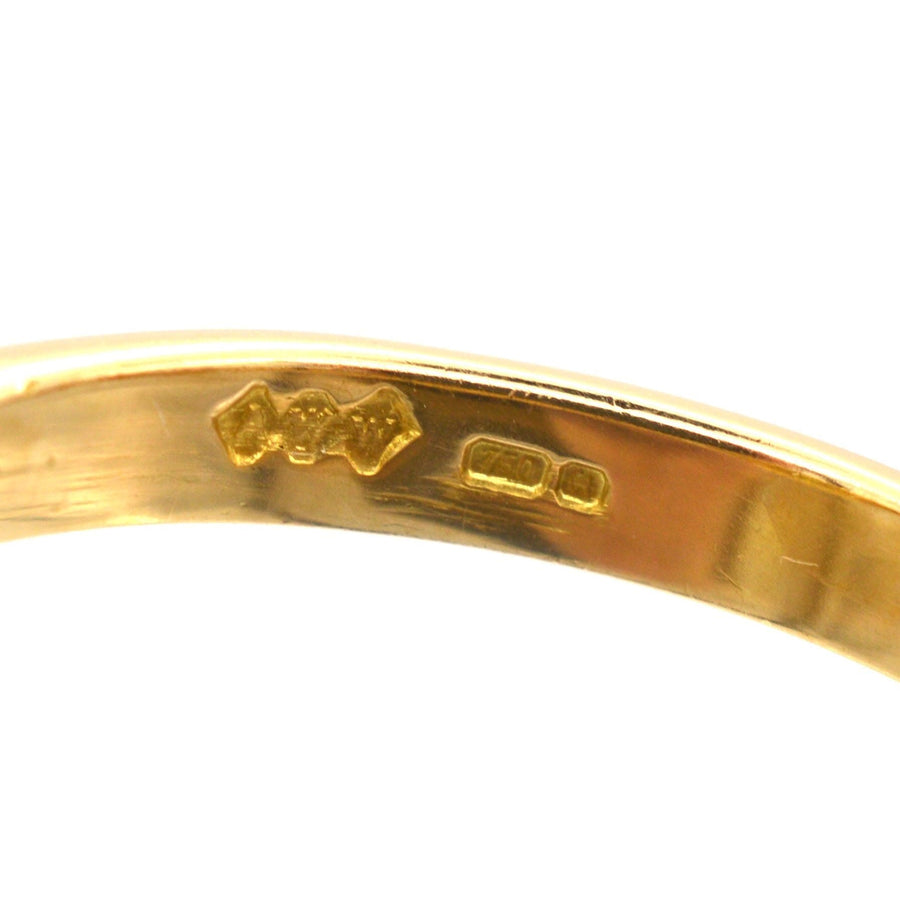 Close-up of the hallmark on an 18ct gold ring, showcasing fine craftsmanship and quality assurance.
