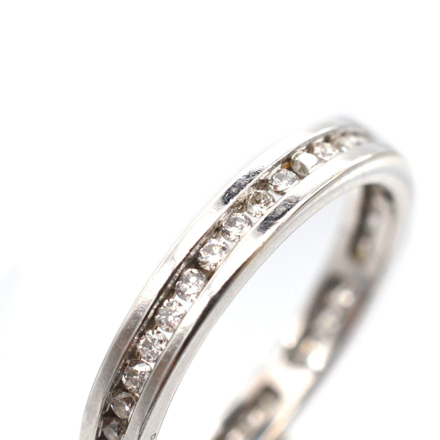 Modern 18ct white gold diamond channel setting eternity ring with exquisite diamonds in a sleek design.