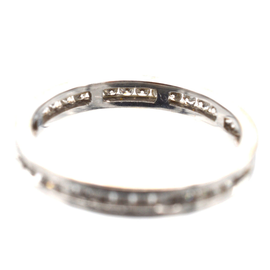 Modern 18ct white gold diamond channel setting eternity ring with exquisite diamond arrangement.