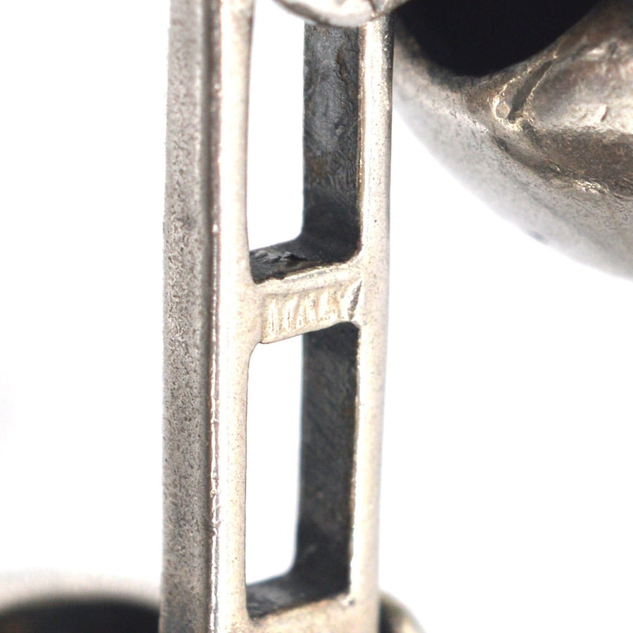 Close-up of modern sterling silver cufflinks with oxidised detail, showcasing craftsmanship and Italy stamp.