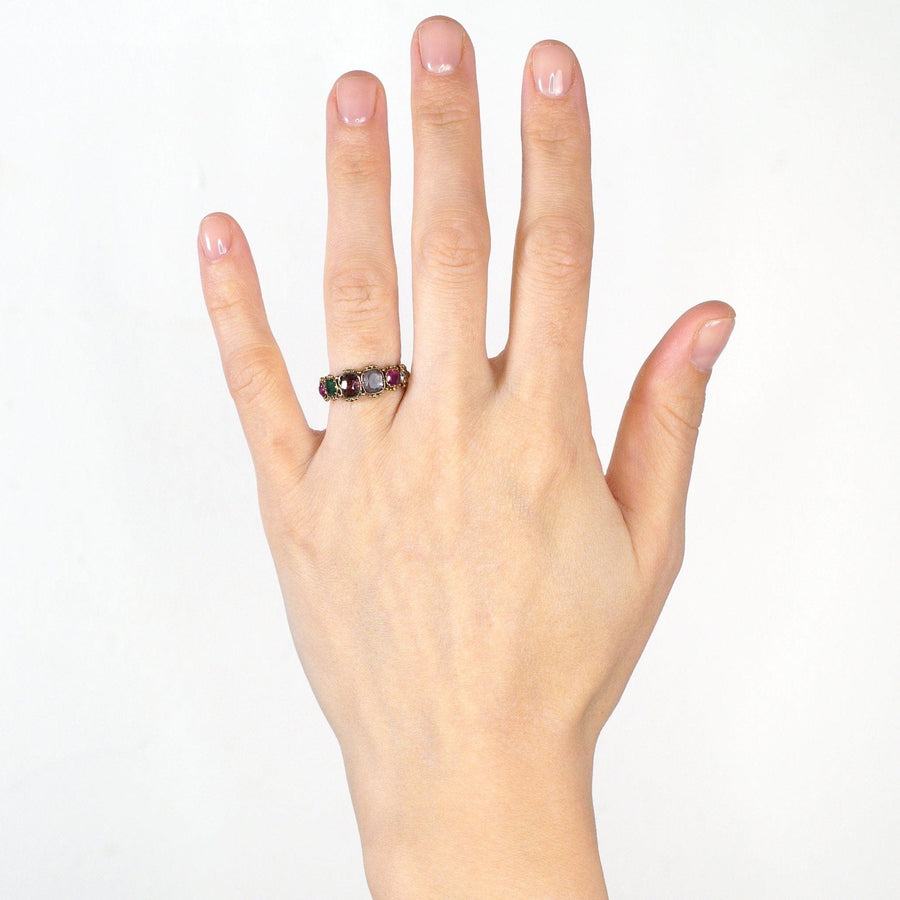 Regency 15ct gold acrostic ring on hand, featuring Ruby, Emerald, Garnet, Amethyst, Ruby, and Diamond spelling 'REGARD'.