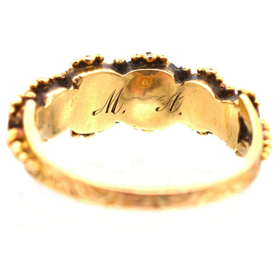 Interior view of Regency 15ct gold acrostic ring, showing engraved initials 'M.H.' with ornate detailing.