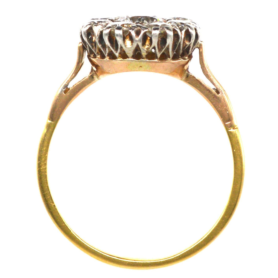 Vintage 18ct gold diamond cluster ring showcasing intricate design and bright white diamonds.
