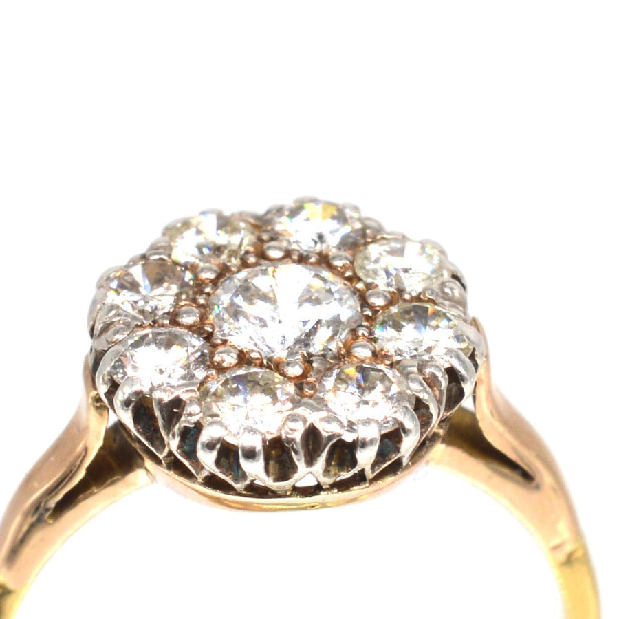 Close-up of a vintage 18ct gold diamond cluster ring featuring 1.1 carats of bright white diamonds.