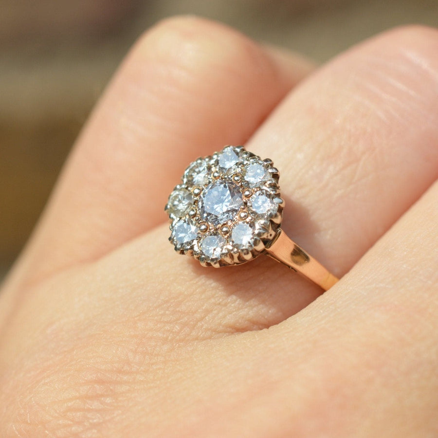 Retro 18ct gold diamond cluster ring on hand, featuring bright 1.1 carat diamonds in a vintage design.
