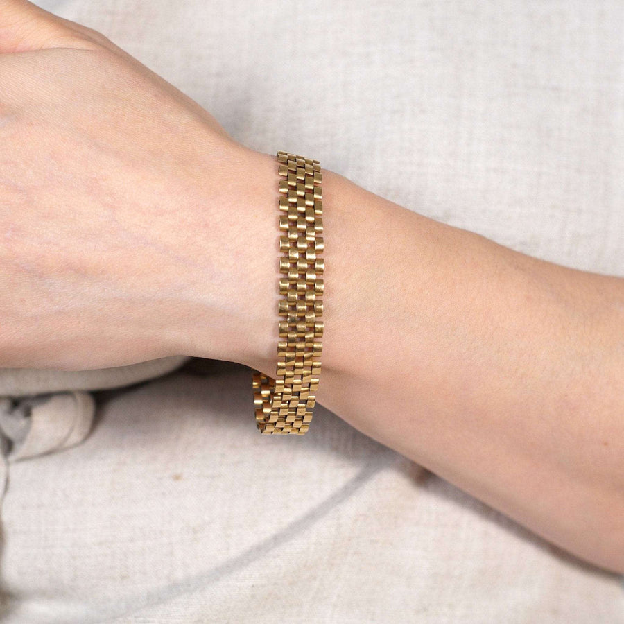 Retro 1940s gold tank bracelet worn on wrist, showcasing its timeless design and luxurious appeal.