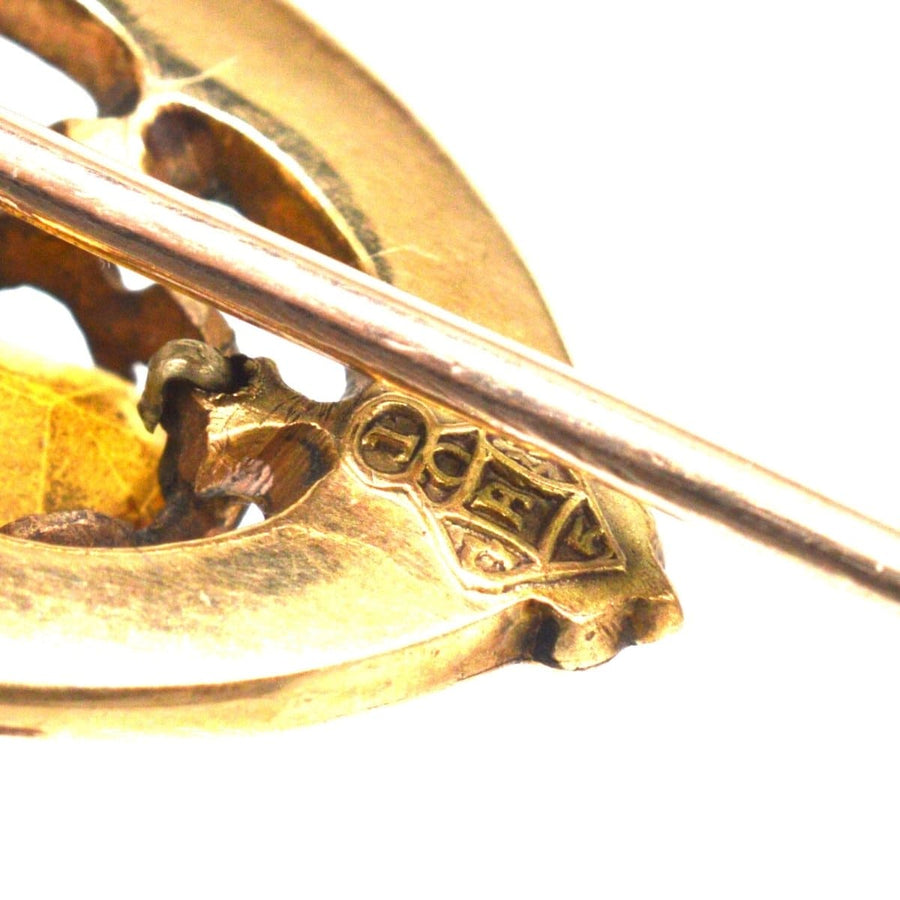 Close-up of a Scottish 9ct gold Luckenbooth shield tie pin featuring intricate design and craftsmanship.