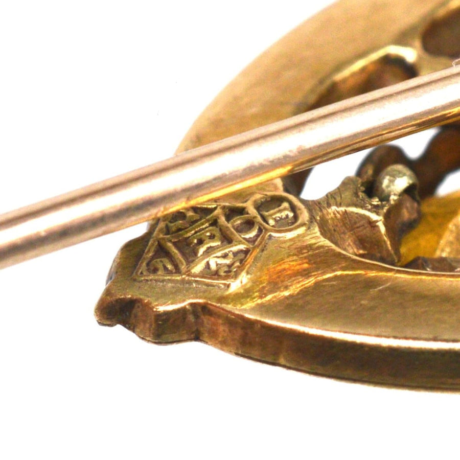 Close-up of Scottish 9ct gold Luckenbooth shield tie pin showcasing Cairngorm Citrine detail.