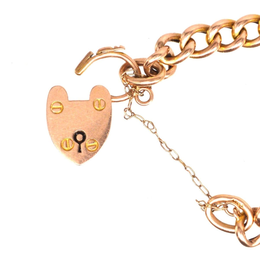 Close-up of a vintage 15ct gold child’s curb bracelet featuring a heart lock, ideal for slender wrists.