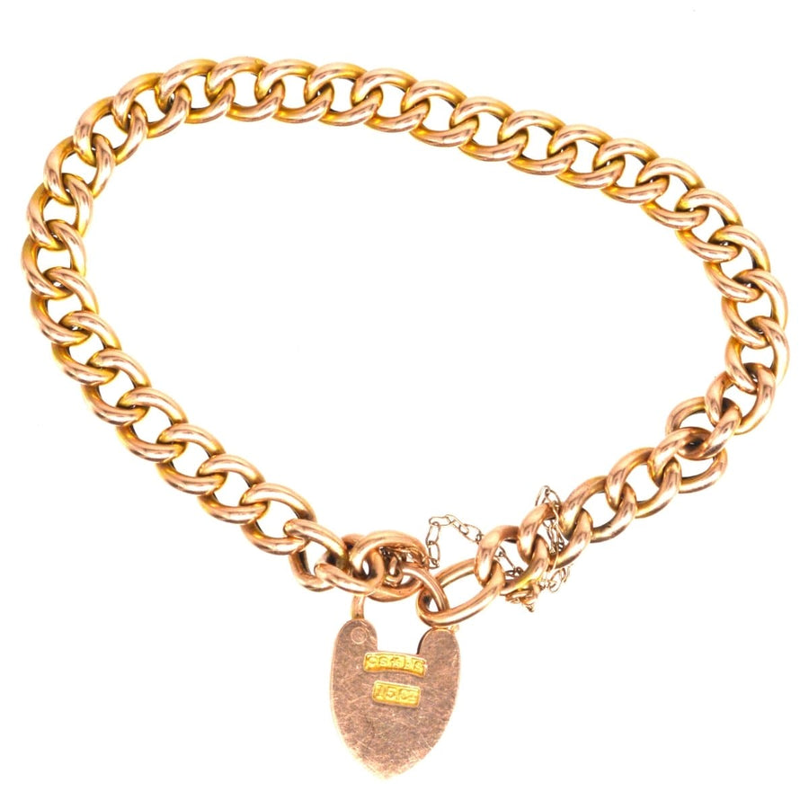 Small Edwardian 15ct gold child's curb bracelet featuring an opening heart lock, circa 1900s, perfect for slender wrists.