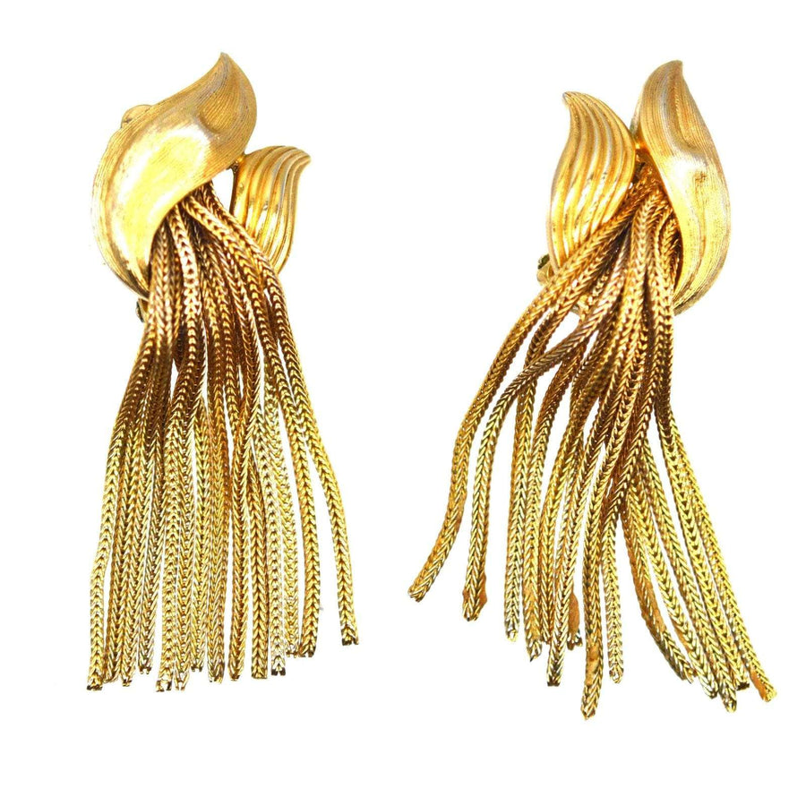 Trifari 1950s gold-tone tassel earrings featuring intricate knot design and flowing fringes.