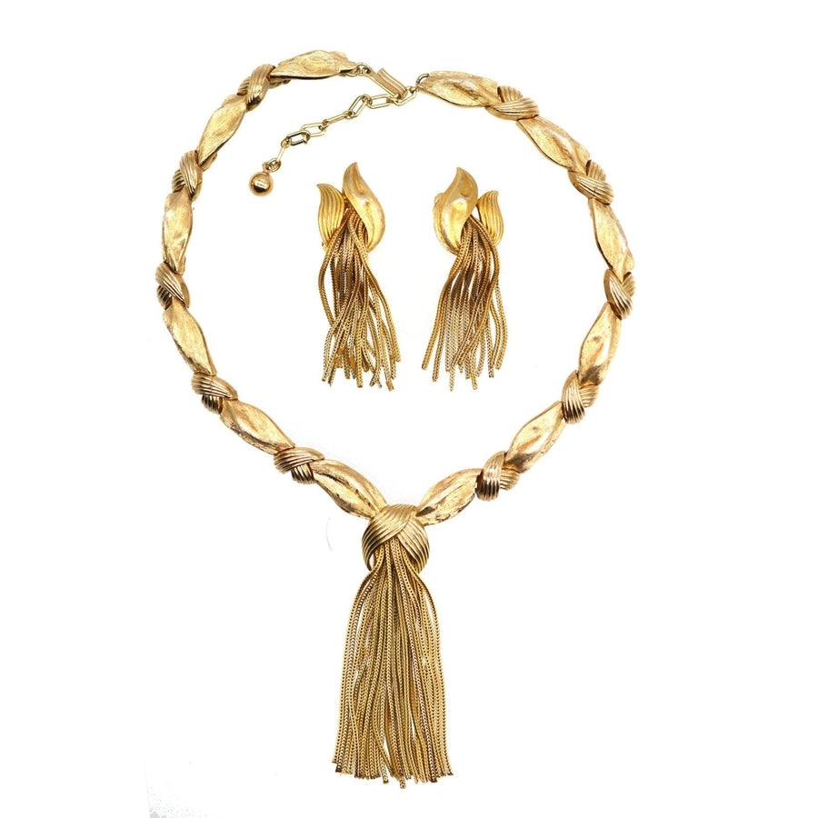 Trifari 1950s gold-tone demi-parure set featuring a knot necklace and tassel earrings.