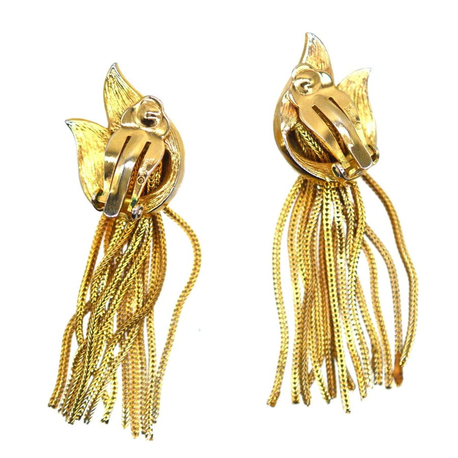 Vintage 1950s Trifari gold-tone tassel earrings, featuring intricate knot design and flowing fringe.