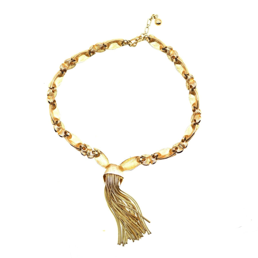 1950s Trifari gold-tone necklace featuring a knot and tassel design, perfect for vintage jewelry lovers.
