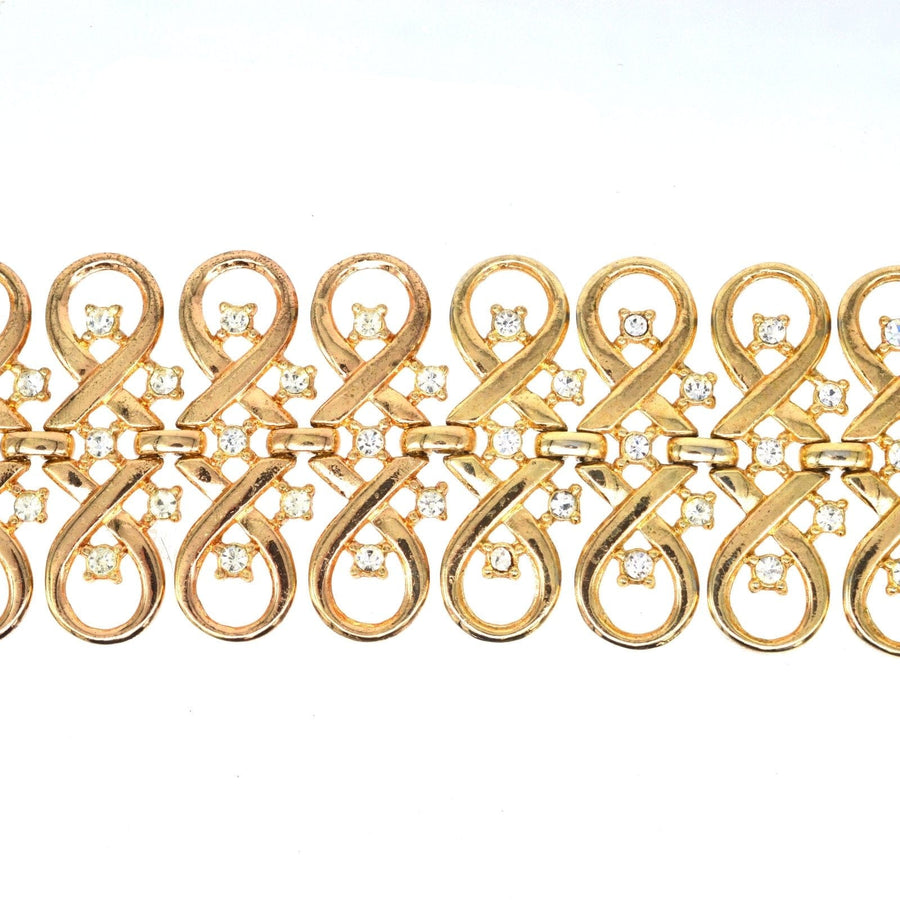 Vintage Trifari gold-tone bracelet featuring interlinked swirls and diamond pastes.