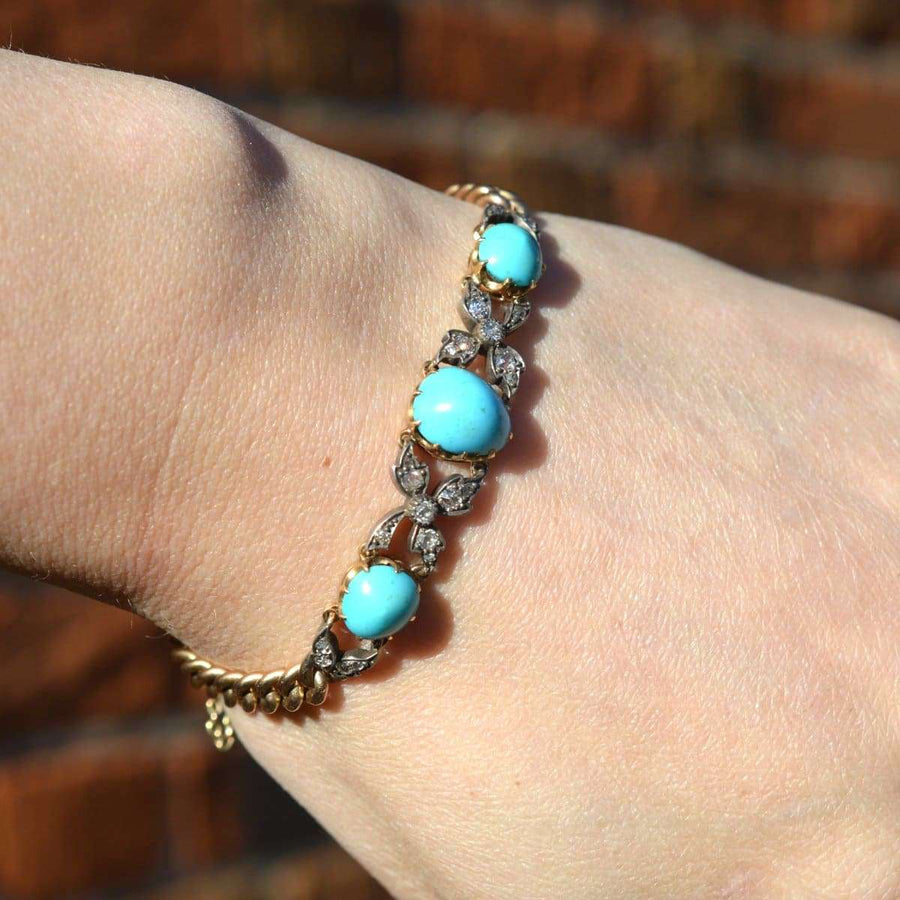 Victorian 15ct gold and silver bracelet with turquoise and diamond on wrist, showcasing timeless elegance.