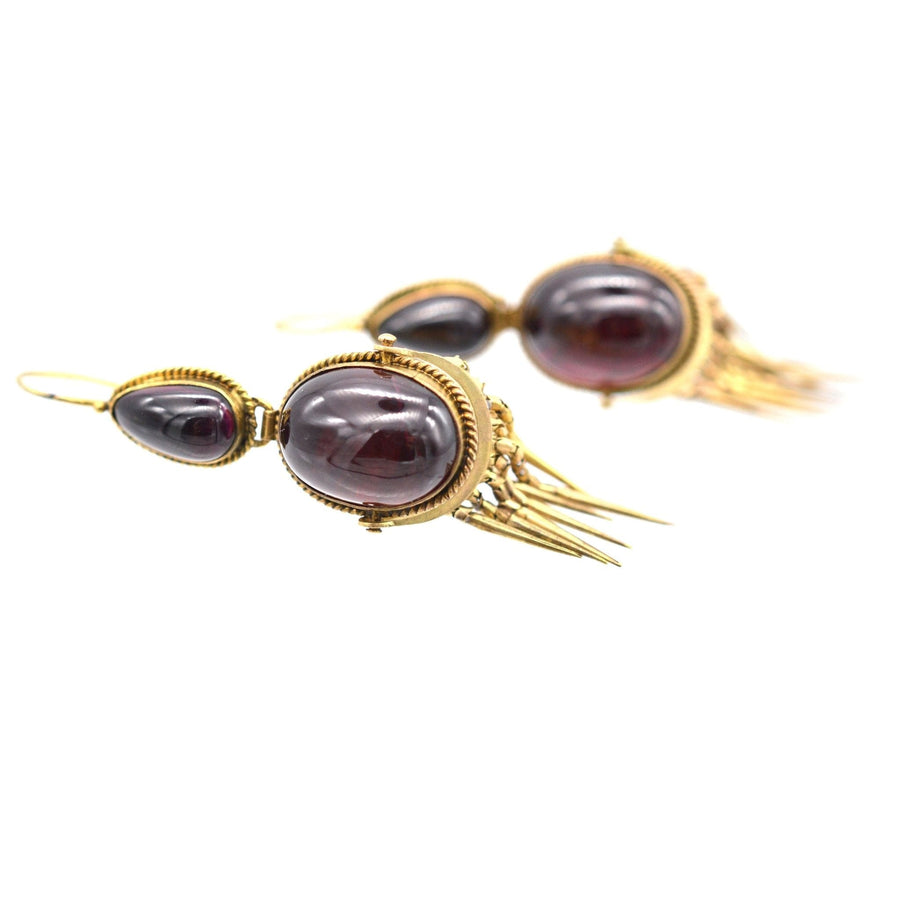 Victorian 15ct gold earrings featuring cabochon garnet and fringe details, showcasing antique jewelry elegance.