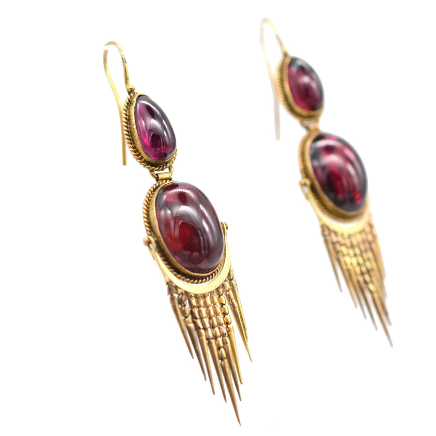 Victorian 15ct gold drop earrings featuring cabochon garnets and intricate gold fringe from the 1860s-1880s.