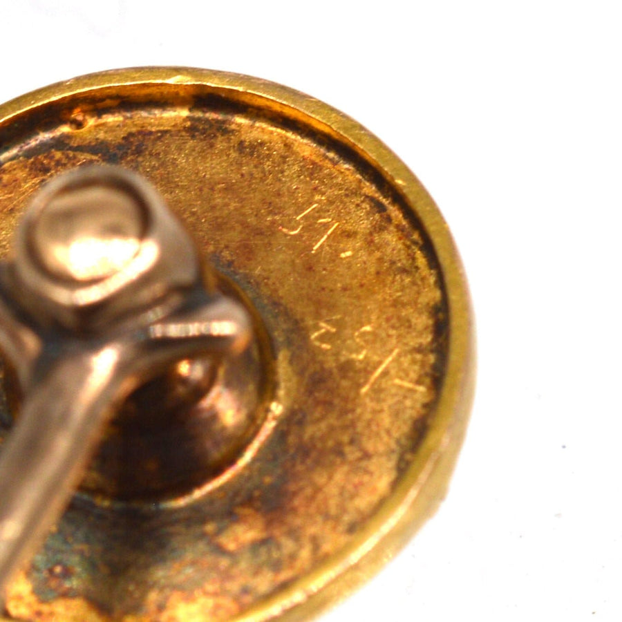 Close-up of the back of a Victorian 15ct gold tie pin, showcasing intricate details and markings.