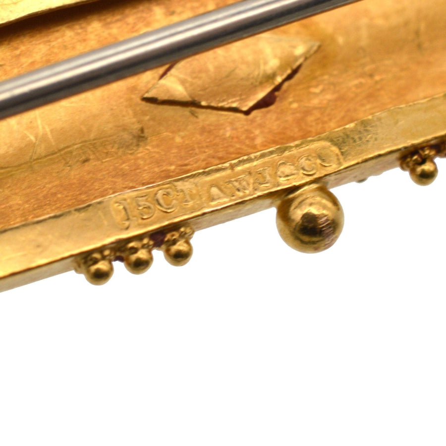 Close-up of hallmark on Victorian 15ct gold Etruscan Revival brooch, showcasing intricate gold craftsmanship.