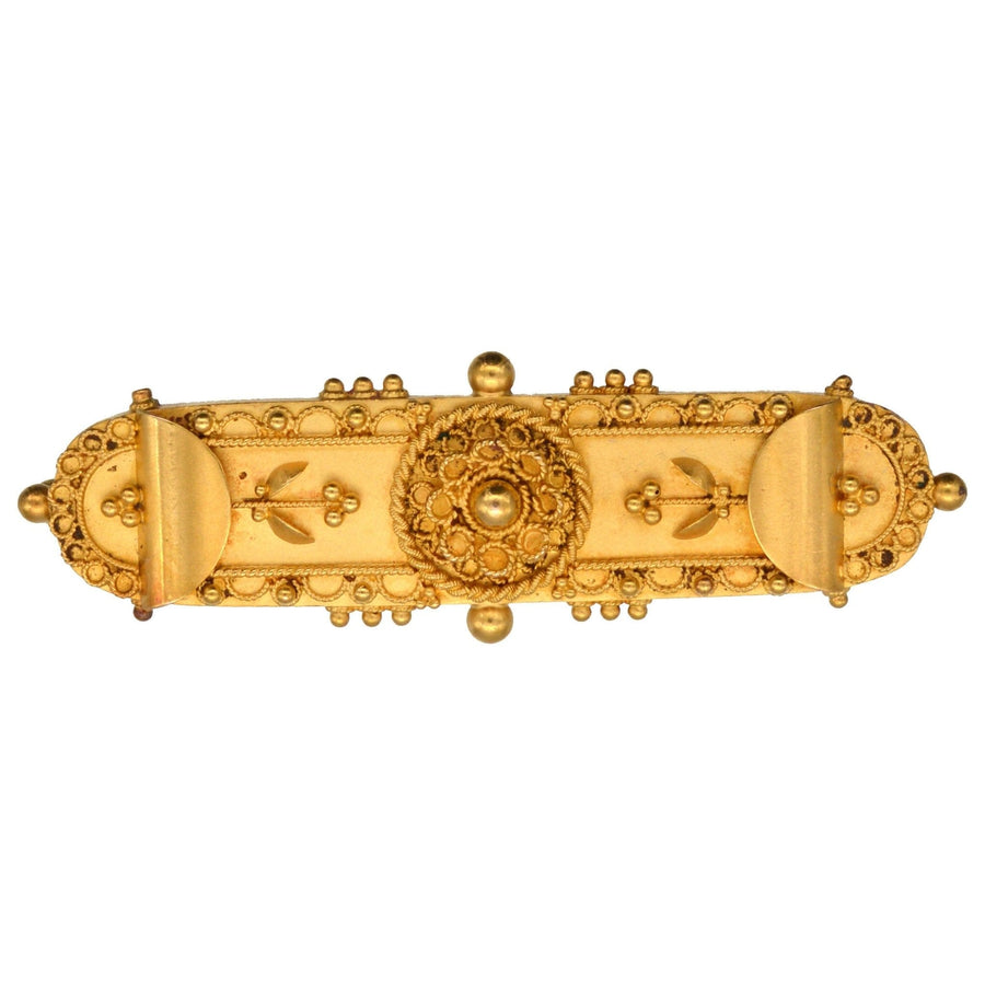 Victorian 15ct gold Etruscan Revival brooch featuring intricate designs, circa 1870s, elegant lapel accessory.