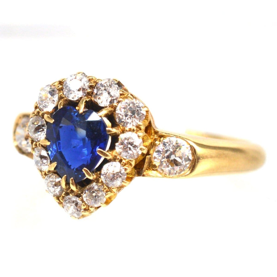Victorian 18ct gold heart-shaped sapphire and diamond cluster ring, showcasing a stunning blue sapphire and sparkling diamonds.