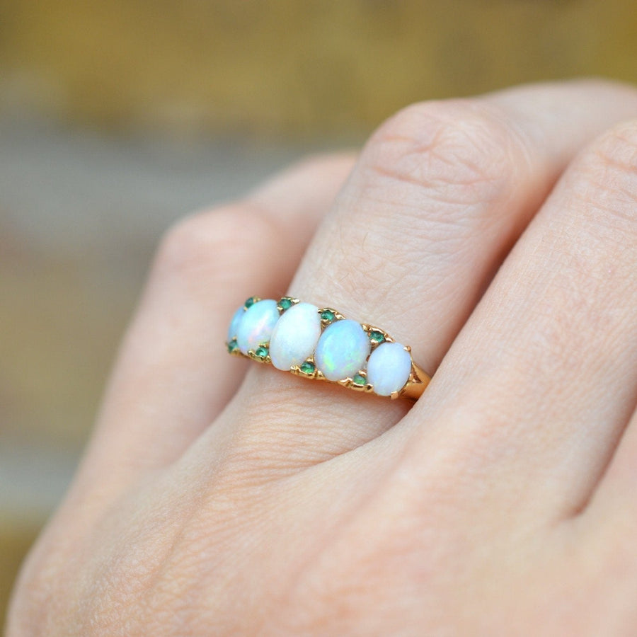 Victorian 18ct gold carved half hoop ring featuring opals and emerald accents, perfect for engagement.