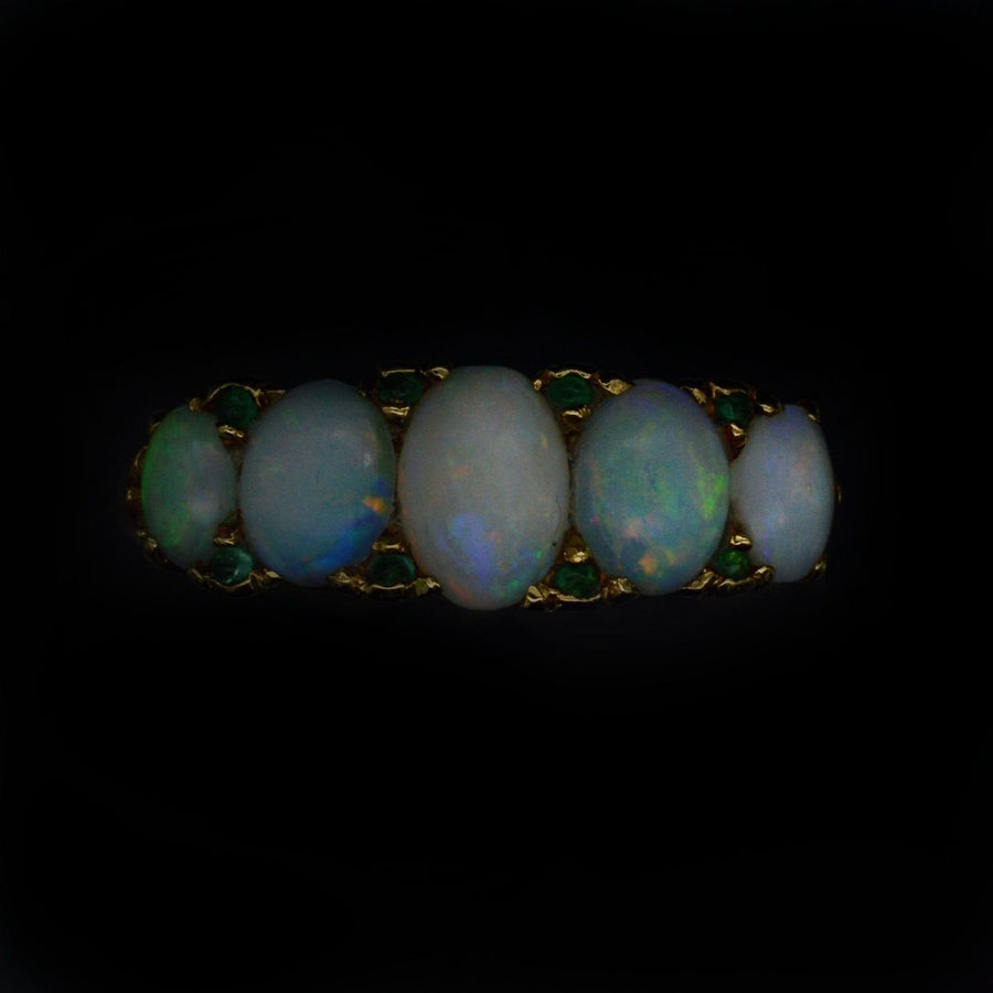Victorian 18ct gold carved half hoop ring with five opals and emerald accents, ideal for engagement.