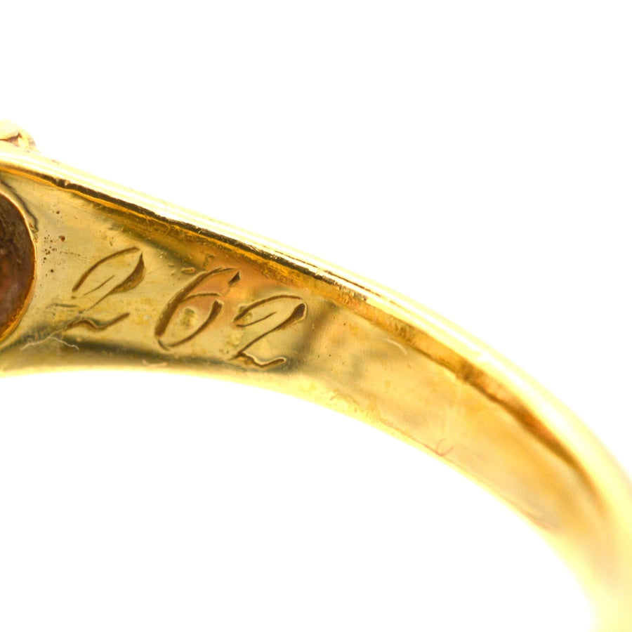 Close-up of carved inscription '262' on the inner band of a Victorian gold ring, highlighting intricate craftsmanship.