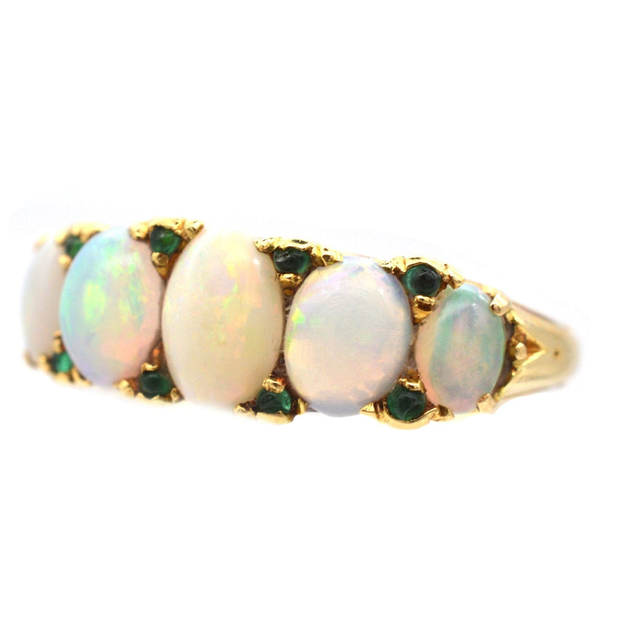 Victorian 18ct gold half hoop ring featuring five opals and emerald accents, perfect as an engagement ring.