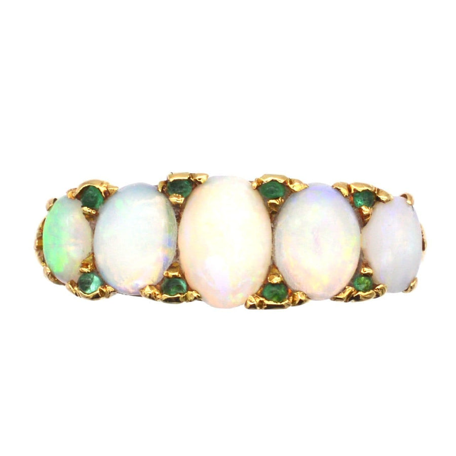 Victorian 18ct gold ring with five opals and emerald accents, perfect for an elegant engagement.