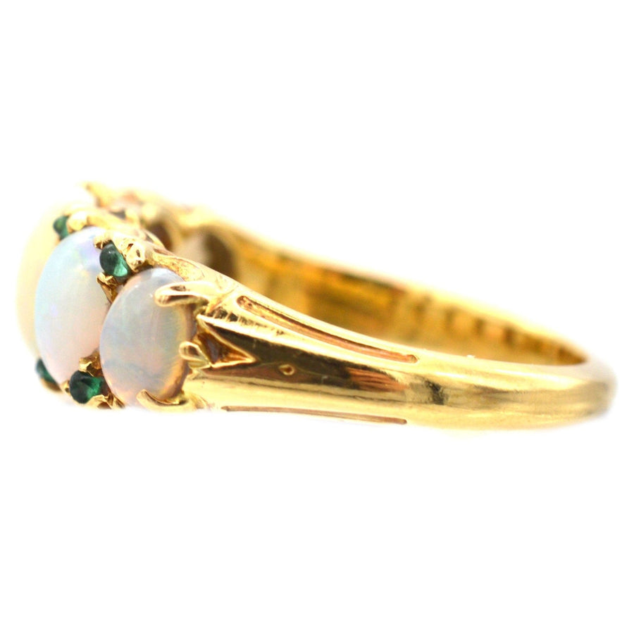 Victorian 18ct gold carved half hoop ring with opals and emerald accents, perfect for engagement or special occasions.