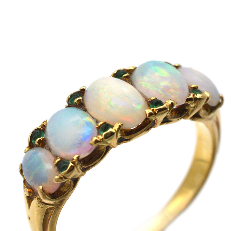Victorian 18ct gold carved half hoop ring featuring five opals and emerald accents, perfect for engagement.